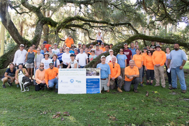 Restoration volunteers standing under an oak tree